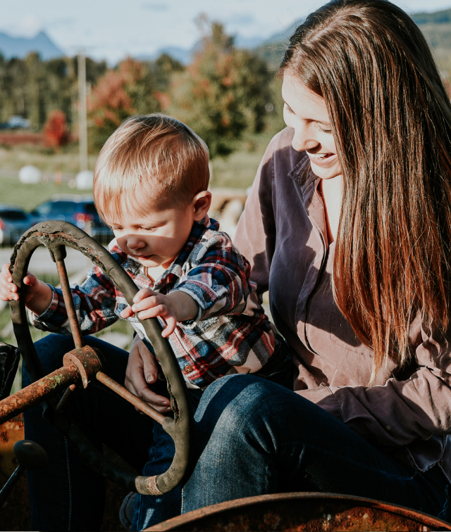 Person And Child Riding Tractor
